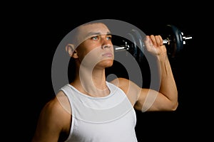 Nineteen year old teen boy exercising with a dumbbell