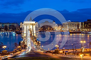 Nineteenth century Chain Bridge Szechenyi Lanchid and Budapest cityscape at night. Budapest, Hungary