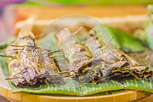 Nipa palm dessert Khanom jaak, Thai sweetmeat made of flour, coconut and sugar, wrapped in nipa palm leaves and grilled.