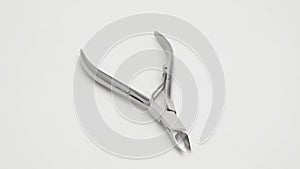 Nippers for manicure and pedicure rotate on a white background.