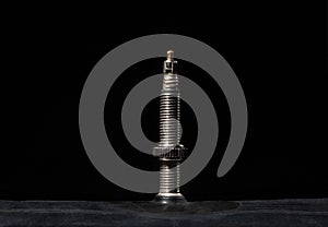 The nipple of a bicycle camera on a black, macro