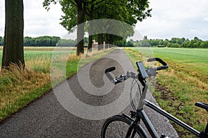 Nispen, Brabant, The Netherlands - Trekking bike standing on a countryside road at the Dutch Belgian border