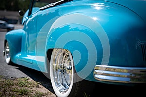 NISSWA, MN - 30 JUL 2022: Close view of back left vivid sky blue antique vintage convertible automobile with the top down at a c