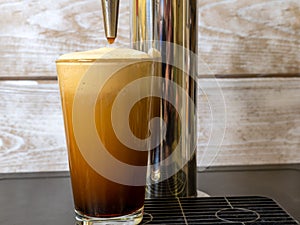 Nitro Cold Brew coffee in a clear glass photo