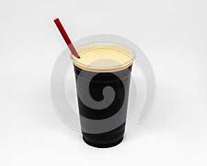 Nitrogen infused cold brew coffee in a clear plastic cup with a red straw.