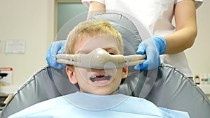 Nitrous oxide in dental clinic while treating young patients with milk teeth. Relaxation of patient before surgical or