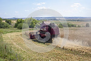 Nizhny Novgorod, Russia - July 17, 2021: Combine harvester harvests wheat from the field close-up. Agricultural work