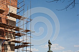 Nizhny Novgorod, Russia, 04.15.2021, restoration of an old red brick wall. scaffolding of wooden planks encircled the ancient defe