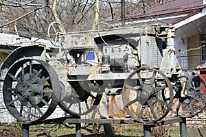 Veteran metal tractor with steel wheels of 1930-s of a local history museum in Nizhyn, Ukraine