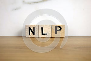 NLP neuro linguistic programming abbreviation from wooden blocks photo