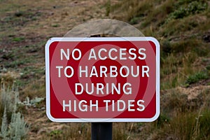 No Access to Harbour During High Tides Signboard at a Coastal Location