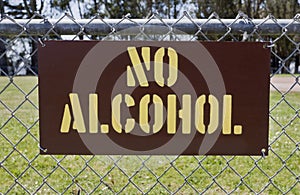 NO ALCOHOL Sign Attached to Park Fence