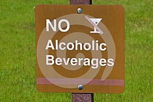 No alcoholic beverages sign over grass