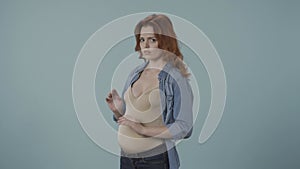 No alkohol during pregnancy. Young pregnant woman refuces to drink wine, making stop gesture to glass. Pregnant woman in