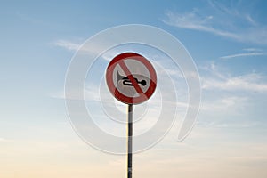 No audible warning devices traffic sign, isolated sunset sky.
