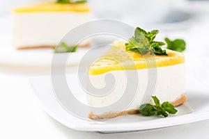 No-bake cheesecake decorated peach jelly and mint leaves