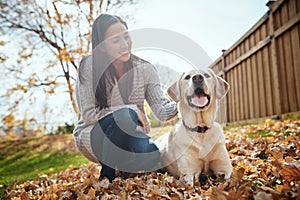 No bones about it, hes the best dog ever. an attractive young woman having fun with her dog on an autumn day in a garden