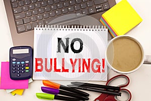 No Bullying text in the office with surroundings such as laptop, marker, pen, stationery, coffee. Business concept for Bullies Pre photo