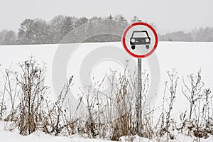 No cars allowed sign on snow covered road