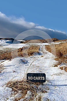 No carts sign on a snow covered links golf course