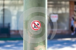 No communism sticker, sickle and hammer in a crossed out red circle on pole