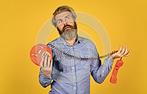 no connection. vintage technology in modern life. young man talking on telephone. senior man hipster showing old