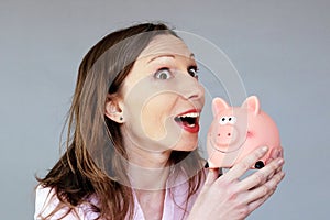 Money savings hopeful woman holding moneybox piggy bank photo