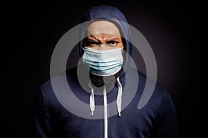 No discrimination. Angry afro american man in medical mask feel furious about racist african people abuse wear fashion