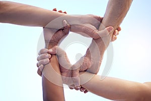 No discrimination between our team. Shot of a group of diverse people with their arms interlinked.