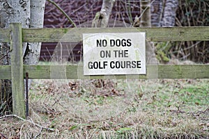 No dogs allowed on golf course sign