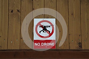 A No Drone sign on a wooden wall