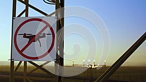No drone zone sign on approach lighting system at runway. Airport airspace perimeter prohibition drones fly sign.