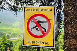 No drone zone sign in Malaysia against a tea plantation