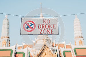 No drone zone Warning sign with buddism temple in background