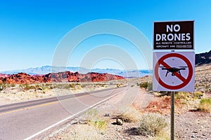 No drones zone warning sign prohibit the launching, landing, or operation of unmanned aircraft. Lonely road, scenic red sandstone