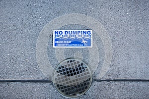 `No Dumping, only rain down the drain` sign