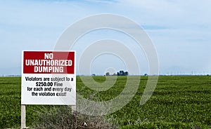No Dumping sign in field photo