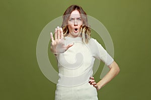 No, enough. Serious young woman showing stop gesture, prohibiting or warning frowning. Quarrel, dispute, conflict