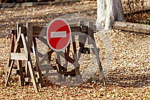 No entry sign in the forest outside the city. Background with copy space for text