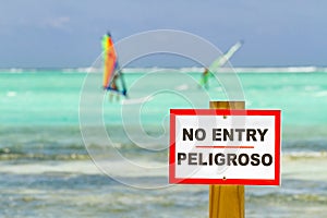 No entry sign in sea with windsurfers