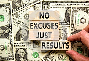 No excuses just results symbol. Concept words No excuses just results on blocks. Businessman hand. Beautiful background from