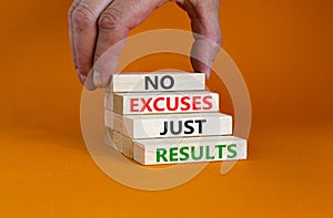 No excuses just results symbol. Concept words No excuses just results on wood blocks. Businessman hand. Beautiful orange table