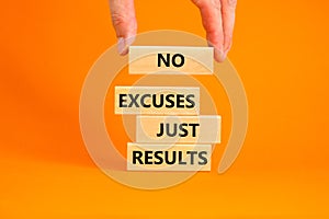 No excuses just results symbol. Concept words No excuses just results on wood blocks. Businessman hand. Beautiful orange table