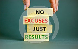 No excuses just results symbol. Concept words No excuses just results on wooden blocks. Businessman hand. Beautiful grey table