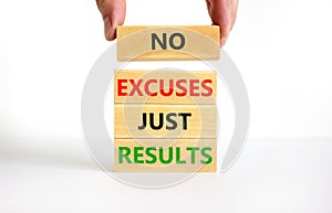 No excuses just results symbol. Concept words No excuses just results on wooden blocks. Businessman hand. Beautiful white table