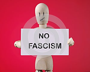 no fascism the phrase on the business card in the hands of a wooden man