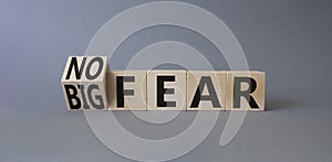 No fear vs big fear symbol. Turned wooden cubes withs words Big fear and No Fear. Beautiful grey background. Business concept.