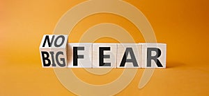 No fear vs big fear symbol. Turned wooden cubes withs words Big fear and No Fear. Beautiful orange background. Business concept.