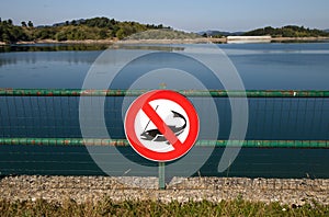 No fishing sign on Giacopiane lake, an artificial reservoir located in the Sturla valley in the municipality of Borzonasca, inland photo