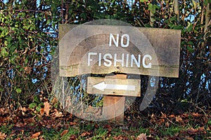 No fishing sign next to a lake.